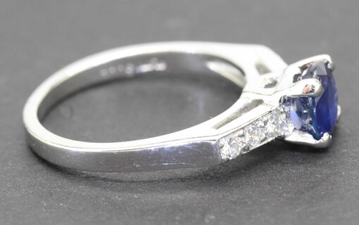 Sapphire and diamond engagement ring with a silver band, perfect for special occasions.