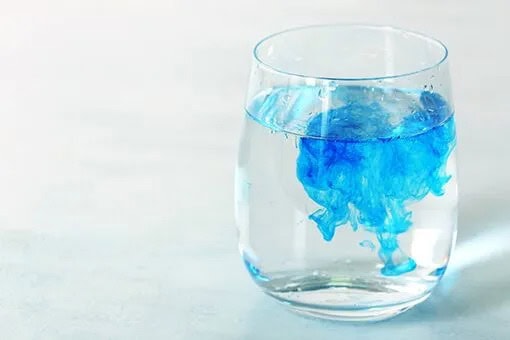 Commercial Water Treatment Bethlehem and Allentown PA Glass of Water with Blue Liquid at an Allentown Commercial Space Before Arrival of Bethlehem Water Treatment Plumbers