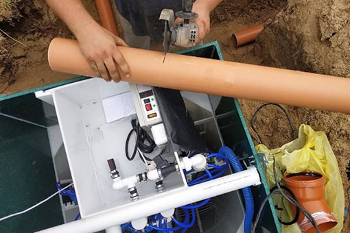 sump-pump-repair-in-bangor-pa Professional Plumber Cutting Pipe to Repair Sump Pump of Bangor Property