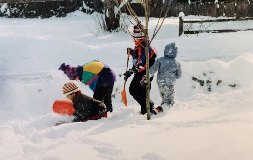 children playing in snow in winter