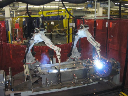 Two robots MIG welding a part