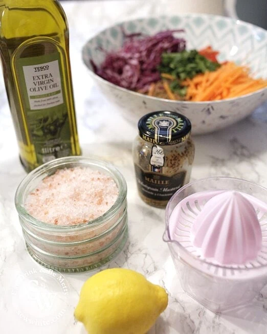 The ingredients for making a lemon mustard and olive oil dressing for vegan salad