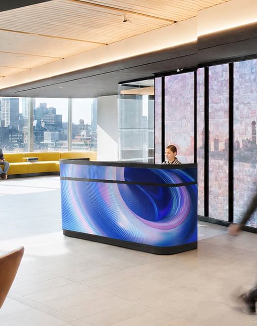 Fronta Series Front Desk LED Display in modern corporate reception lobby