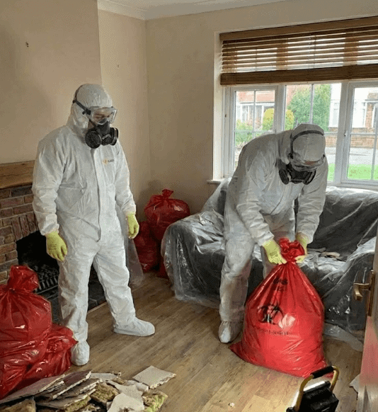 Emergency team performing Asbestos Removal Grantham in a residential living room.