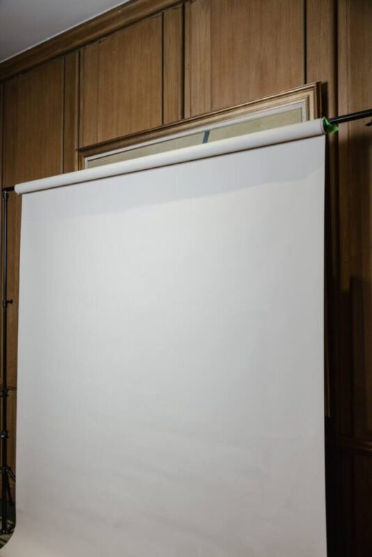 White roll-down studio backdrop for clean, timeless photo booth portraits