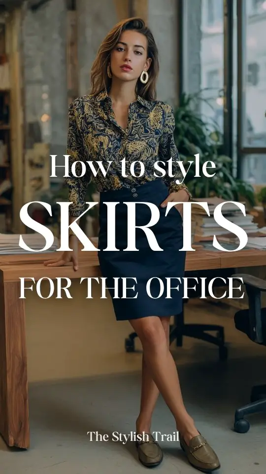 A woman wears a business casual with a navy pencil skirt with a patterned blouse and loafers