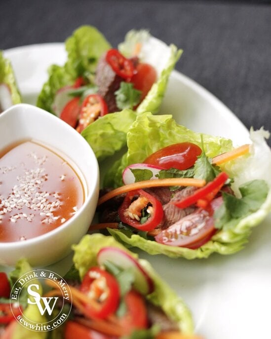 Vietnamese Inspired Beef Salad Bites serving, the bright colurs of the tomatoes, chillies, carrots and green herbs make it very appetising. With a sweet chilli dipping sauce