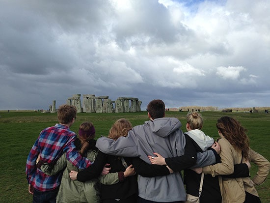 Students facing towards Stonehenge in the UK