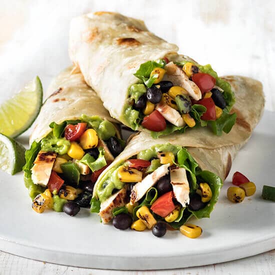 Fiesta chicken wrap from The Morrissey House, bursting with flavor and vibrant ingredients, wrapped in a soft tortilla for a satisfying meal.