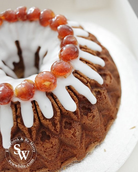 Cherry cake perfect for parties drizzled with white icing and topped with cherries