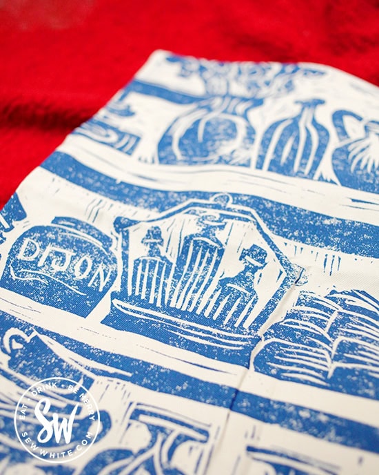 Detail of the lino print apron by Katie Guy