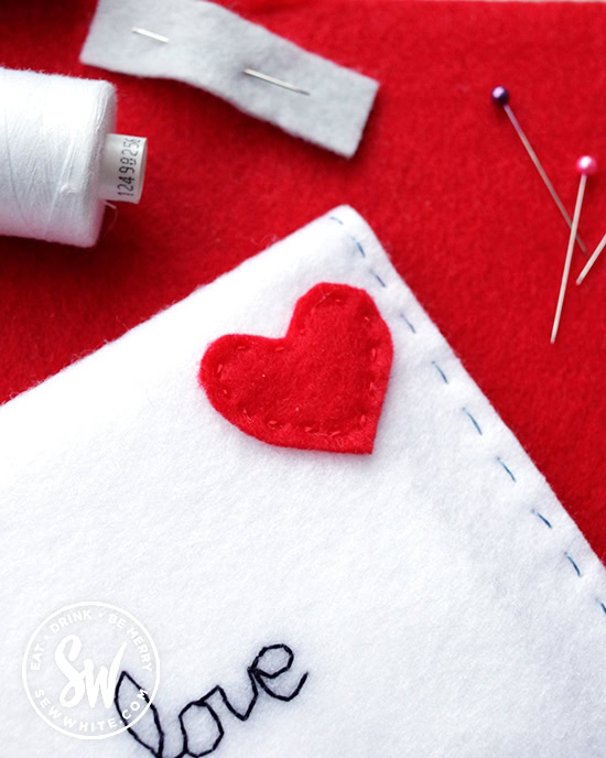 red felt heart looking like a stamp on the felt envelope