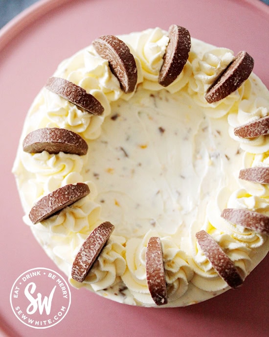 Terry's chocolate orange segments on whipped up spirals of cream on the cheesecake