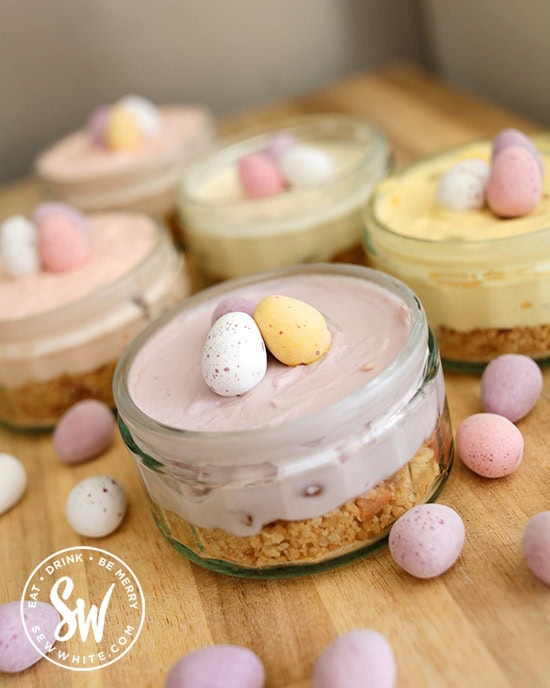 no bake Easter mini cheesecakes perfect for sharing. Individual mini egg cheesecakes in mini egg pastel colours.