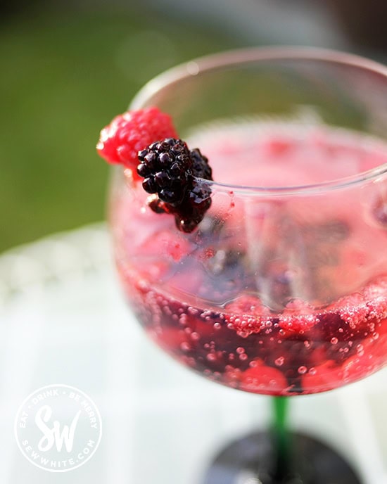 summer berries cocktail made with frozen fruit.