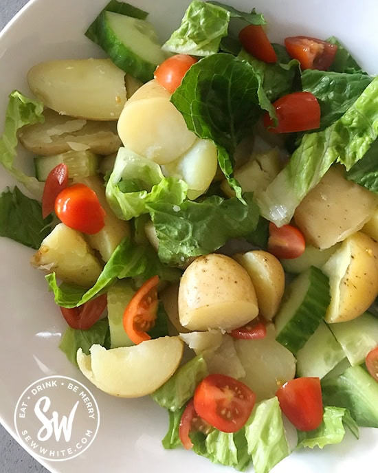 new potato salad with lettuce, cucumber and tomatoes.