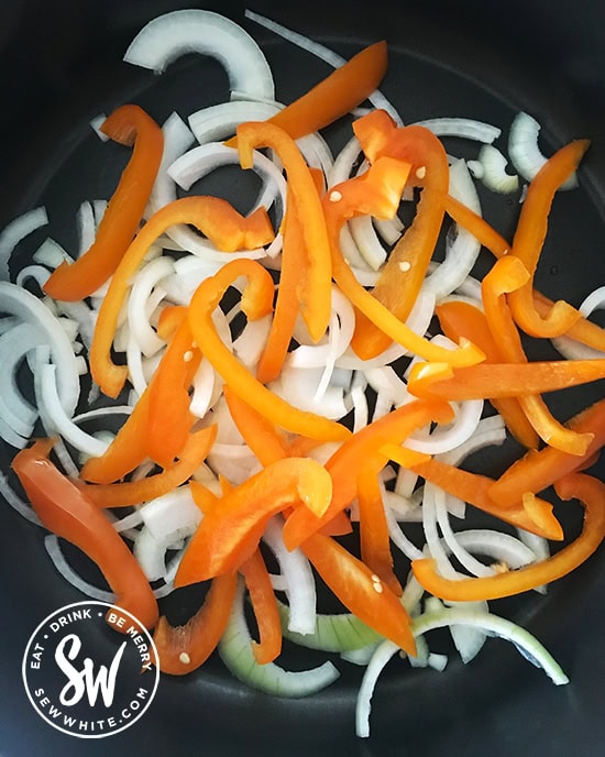 onion and orange pepper in a pan