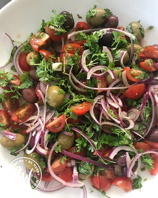 A beautiful mix of fresh parsley, basil, red onion, cherry tomatoes and mixed olives for the healthy leftover roast chicken pasta salad.