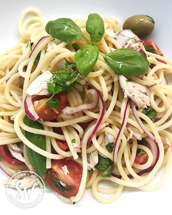 Healthy Leftover Roast Chicken Pasta Salad mixed together with red onion, tomato and topped with fresh basil