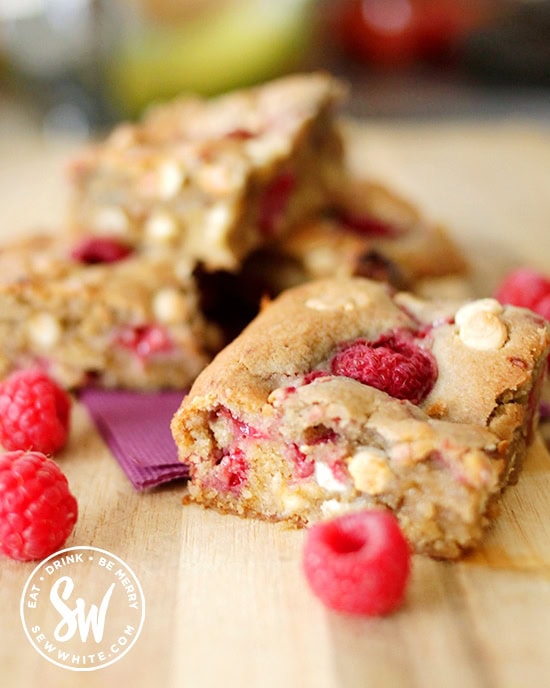 Squidgy giant chunky cookie made with raspberries and white chocolate chips. An easy traybake for the children and family baking.