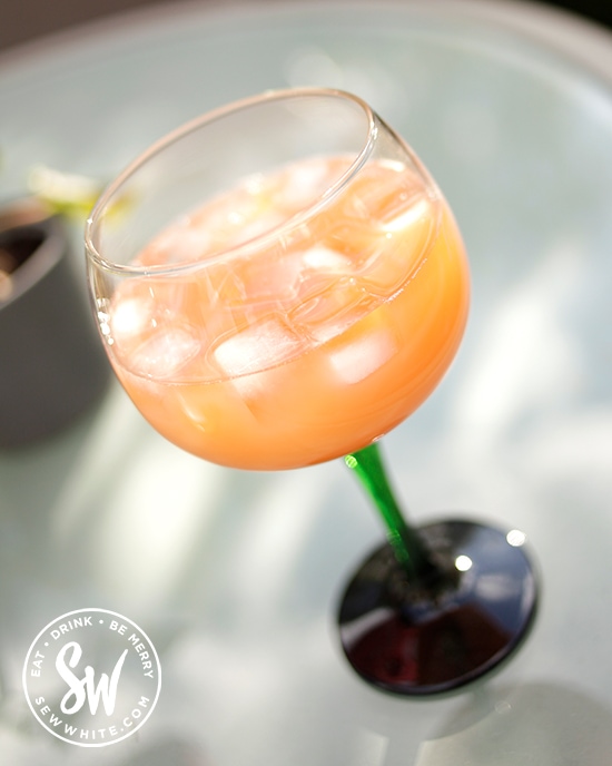 orange cocktail made with Aperol and apple juice