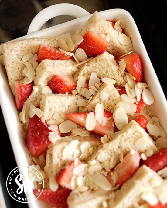 Fresh Strawberry Bread and Butter Pudding topped with flaked almonds ready for the oven.