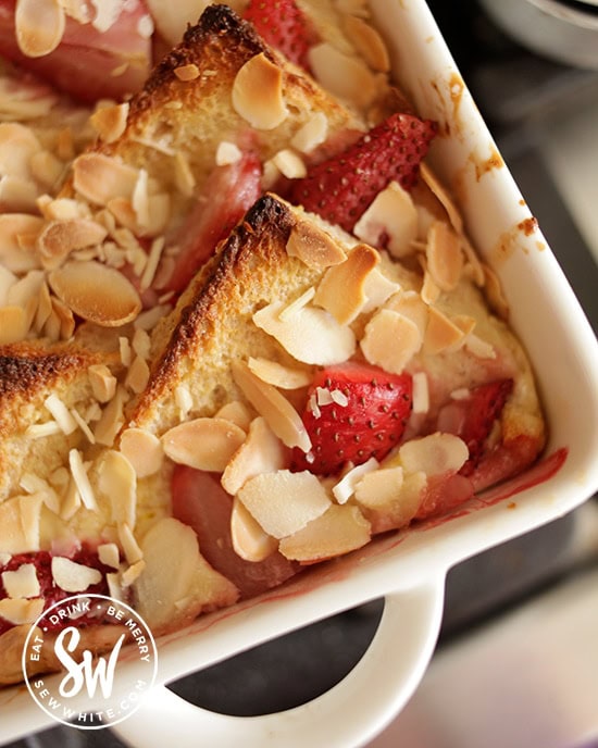 Roast strawberry on a warm bed of bread and butter pudding topped with almonds