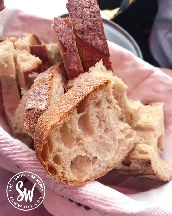 Sourdough bread ready to be eaten in a cloth bread basket