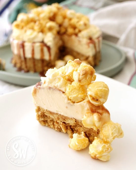 A slice of cheesecake with popcorn on ready to be served