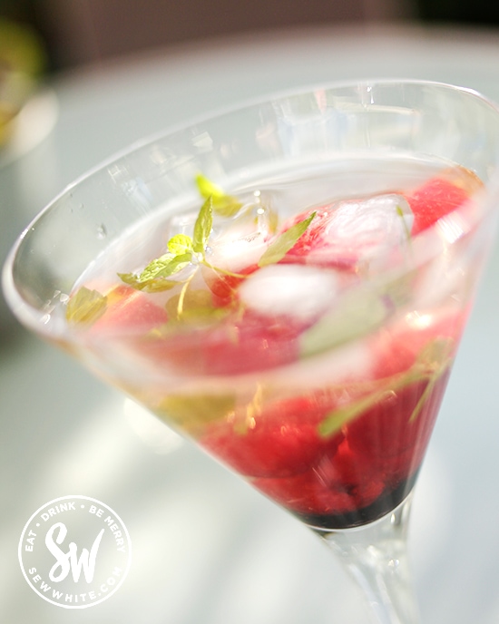 Easy raspberry cocktail with fresh raspberries and sprig of mint 