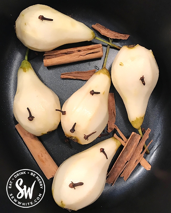 cinnamon sticks and cloves with pears in a slow cooker