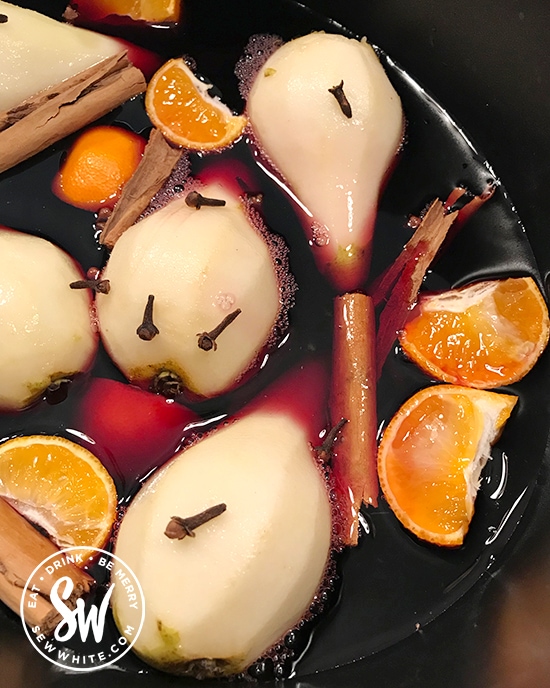 Mulled Wine Pears with oranges and spices in a slow cooker