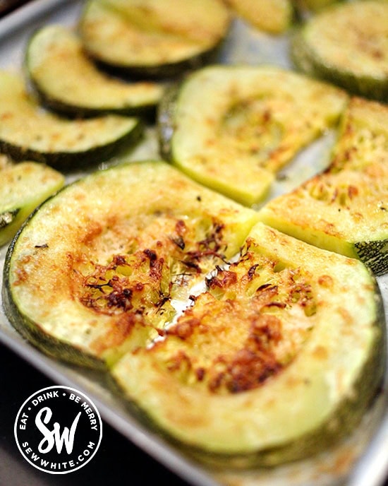 Golden brown Roasted Parmesan Courgettes on a baking tray