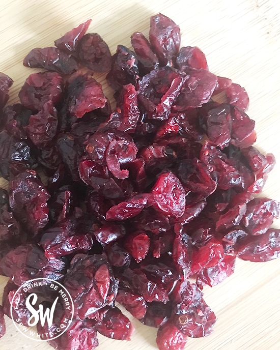 dried cranberries on a chopping board