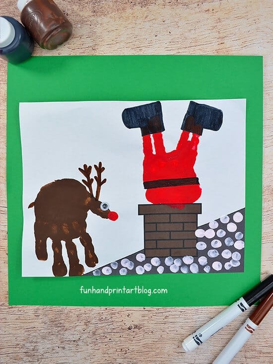 christmas card of stuck Santa in chimney featuring a handprint reindeer 