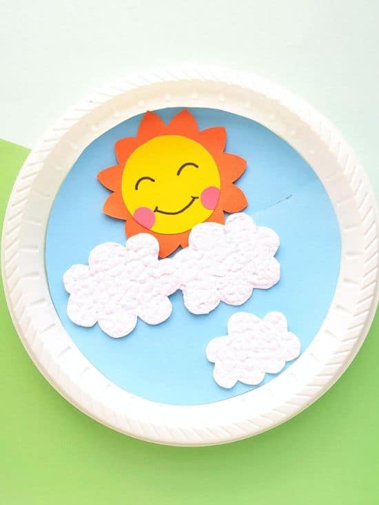 sun and clouds on paper plate with blue sky