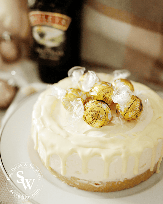Golden Lindt truffles on a cheesecake.