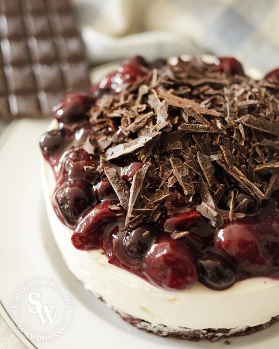 black forest dark chocolate and cherry no bake cheesecake topped with shards of chocolate