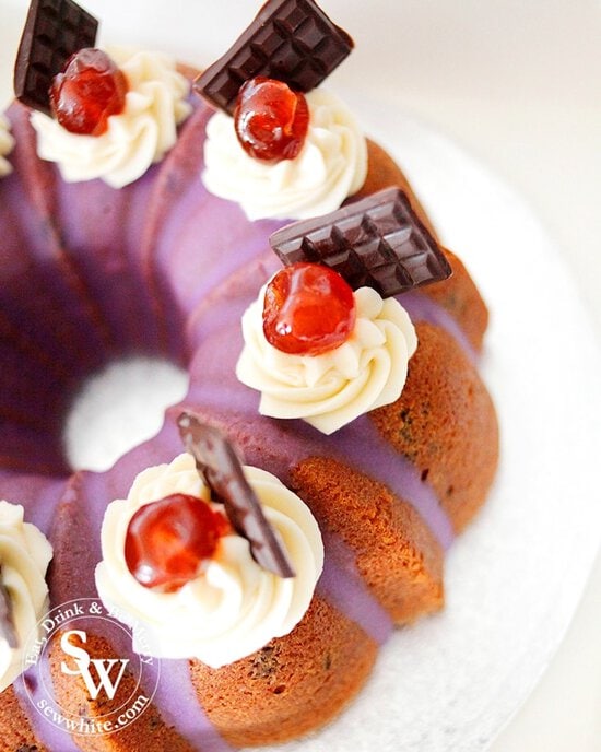 Mini chocolate bars on the buttercream swirls with cherries on the Easy Black Forest Bundt Cake