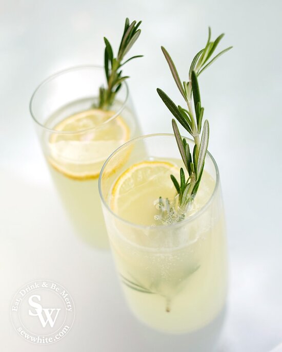 Ready to serve rosemary lemonade garnished with rosemary and a lemon slice.