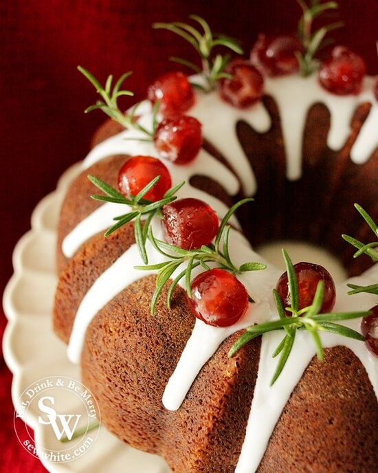 Close up of the fresh rosemary and glacé cherries on the black forest bundt cake