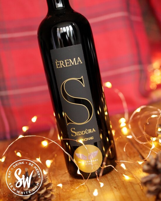 Siddura wine from Independent Wine on a wooden table with fairy lights in the drink gift guide