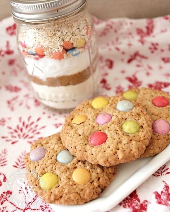 cookie mix jar next to the finished cookies on a white plate