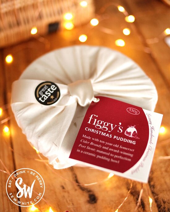 Figgy's Christmas pudding wrapped in cotton with a great taste sticket surrounded by fairy lights on the Sew white Eat Gift Guide