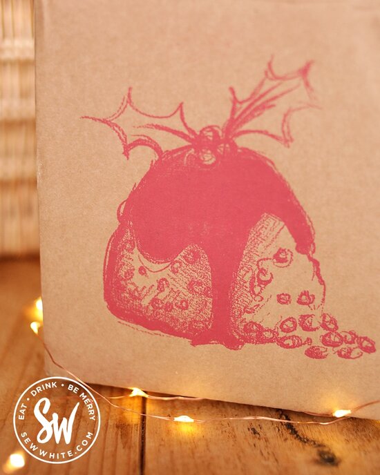 Figgy's pudding box with Christmas pudding illustration on the Sew White Eat gift guide.