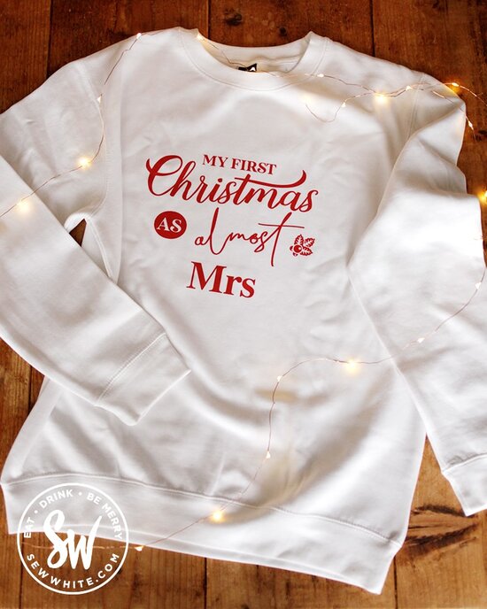 pink positive personaslied white sweatshirt with red writing on the be merry gift guide