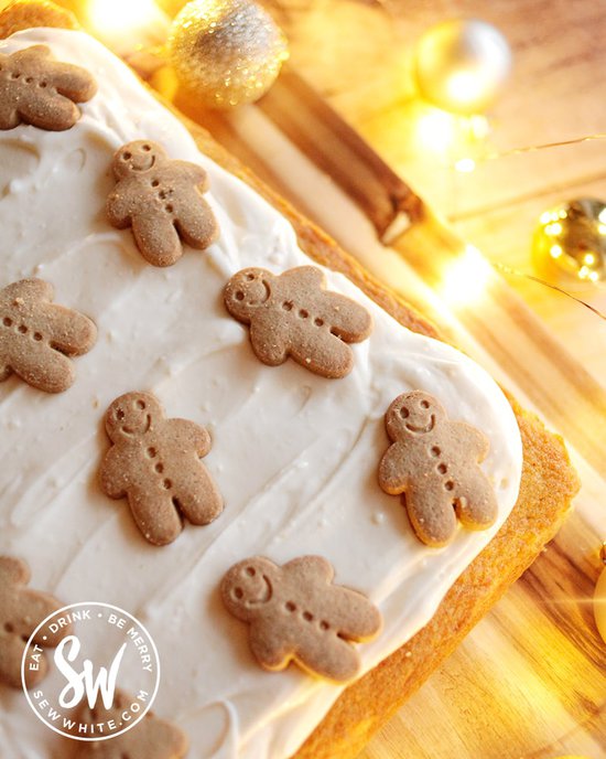 Smiling gingerbread men on a ginger traybake cake