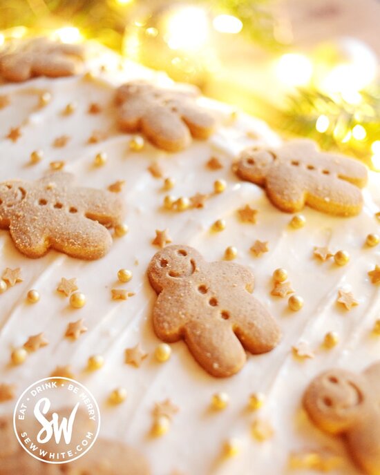 Gingerbread men on a ginger buttercream cream cheese frosting with gold sprinkles