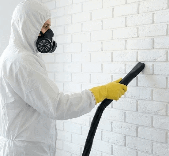 Technician using an H-Type vacuum for cleanup after Asbestos Removal Grantham. Asbestos Abatement Grantham.