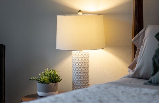 Soft bedside lighting and simple, calming details create a cozy, restful atmosphere. Thoughtfully styled for relaxed evenings and comfortable nights.